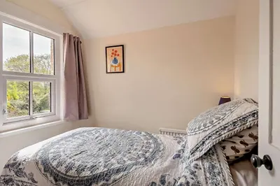 a bedroom with a bed and a window at 3 Bed in Bawdsey oc-p31139 in Bawdsey