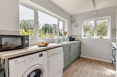 a kitchen with a washer and dryer and two windows at 3 Bed in Bawdsey oc-p31139 in Bawdsey