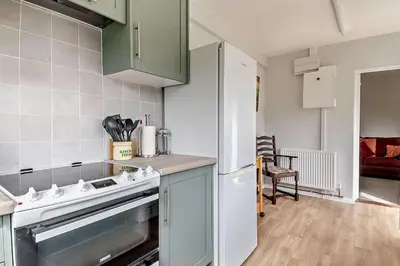 a kitchen with a stove and a white refrigerator at 3 Bed in Bawdsey oc-p31139 in Bawdsey