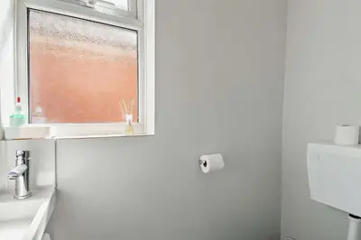 a white bathroom with a window and a sink at 3 Bed in Bawdsey oc-p31139 in Bawdsey