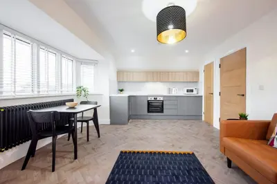a living room with a table and a couch at 8 The Royal Serviced Apartments ,Harwich, One Bed Parking, Fast Wifi, Space Apartments in Parkeston