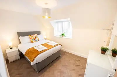 a small bedroom with a bed and a window at 8 The Royal Serviced Apartments ,Harwich, One Bed Parking, Fast Wifi, Space Apartments in Parkeston