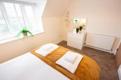 a bedroom with a bed with two pillows on it at 8 The Royal Serviced Apartments ,Harwich, One Bed Parking, Fast Wifi, Space Apartments in Parkeston