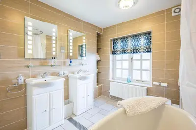 a bathroom with a tub and a sink at Market Cross House, Aldeburgh. Sea front holiday home in Aldeburgh