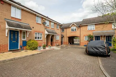 a house with a tent parked in the driveway at Loughton Hideaway: Cozy 1BD Near Tube & Nature in Theydon Bois