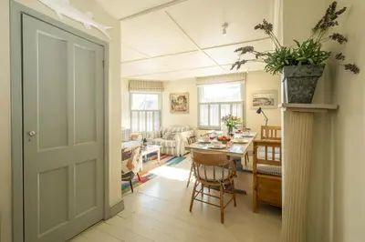 a living room with a table and a dining room at Seagulls - Aldeburgh Coastal Cottages in Aldeburgh