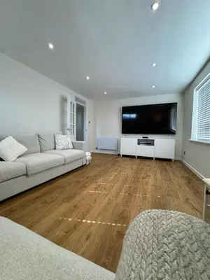 a living room with a couch and a flat screen tv at Fantastic family flat in Frinton in Kirby Cross