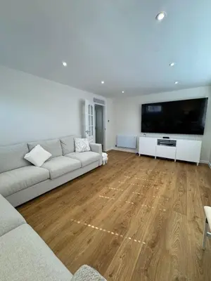 a living room with a couch and a large flat screen tv at Fantastic family flat in Frinton in Kirby Cross