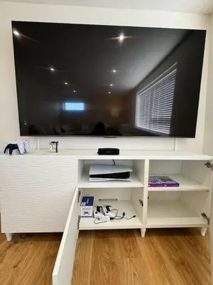 a flat screen tv sitting on top of a white entertainment center at Fantastic family flat in Frinton in Kirby Cross