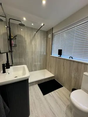 a bathroom with a sink and a shower and a toilet at Fantastic family flat in Frinton in Kirby Cross