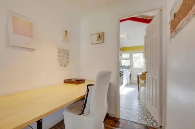 a home office with a desk and a chair at Pass the Keys Charming Ground Floor Flat with Free Parking in Cambridge