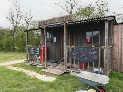 a small wooden shack with a sign on it at Buttercup Cow Shed 3 in Woodbridge