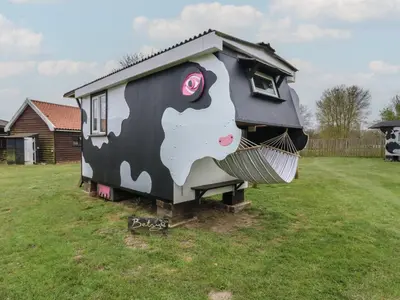 a house with a cow painted on the side of it at Betsy Cow Shed 2 in Woodbridge