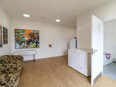 a living room with a couch and a refrigerator at Betsy Cow Shed 2 in Woodbridge