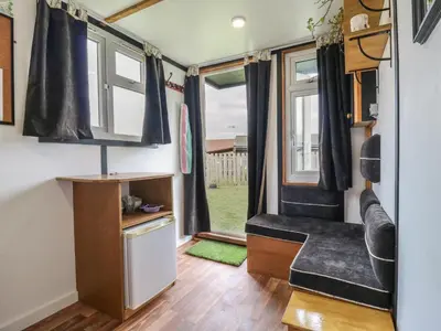 a tiny house with a kitchen and a living room at Bluebelle Cow Shed 5 in Woodbridge