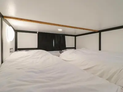 two beds in a room with white sheets at Bluebelle Cow Shed 5 in Woodbridge