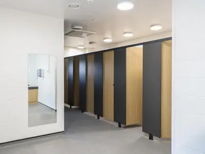 a row of lockers in a hallway with a mirror at Bluebelle Cow Shed 5 in Woodbridge