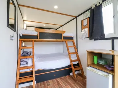 a bunk bed in a tiny house at Bluebelle Cow Shed 5 in Woodbridge