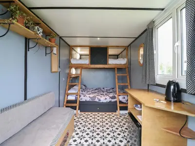 a small room with bunk beds and a desk at Dozy Dotty Cow Shed 4 in Woodbridge