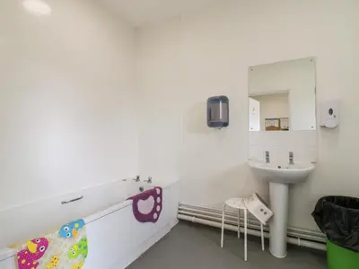 a bathroom with a sink and a mirror at Dozy Dotty Cow Shed 4 in Woodbridge