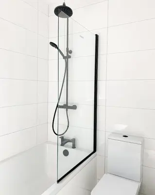 a shower with a glass door next to a toilet at Relaxing home Leigh on Sea in Southend-on-Sea