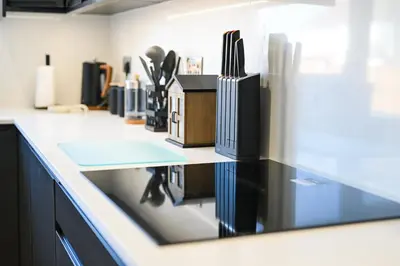 a kitchen counter with a counter top with utensils at Relaxing home Leigh on Sea in Southend-on-Sea