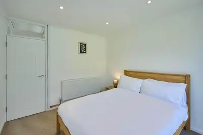 a bedroom with a white bed and a closet at Host & Stay - Park View in Thetford