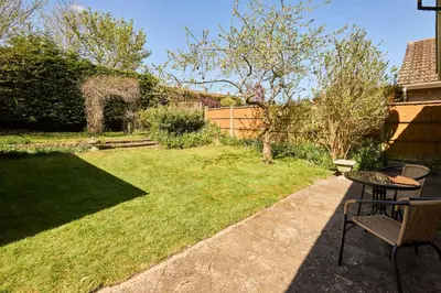 a garden with a table and chairs in a yard at Host & Stay - Park View in Thetford