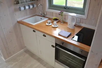 a kitchen with a sink and a counter top at Shepherds Hut 7 in Bedfield
