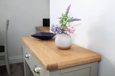 a vase with flowers in it sitting on a counter at Promenade Apartment in Maldon