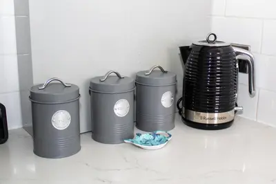 a group of three trash cans sitting on a counter at Promenade Apartment in Maldon