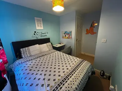 a bedroom with a bed with a black and white comforter at Rooms in Granary House, Newmarket in Newmarket