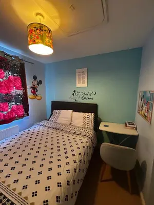a small bedroom with a bed and a desk at Rooms in Granary House, Newmarket in Newmarket