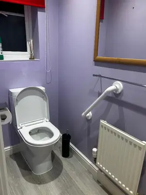 a bathroom with a white toilet and a radiator at Rooms in Granary House, Newmarket in Newmarket