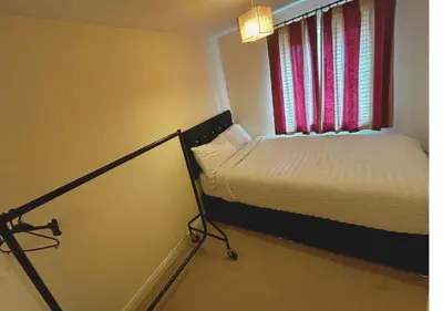 a small bedroom with a bed and a window at Rooms in Granary House, Newmarket in Newmarket