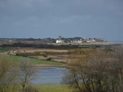 a river in a field with houses in the background at Sea Crest in Aldeburgh