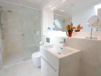 a bathroom with a sink and a shower and a toilet at Sea Crest in Aldeburgh