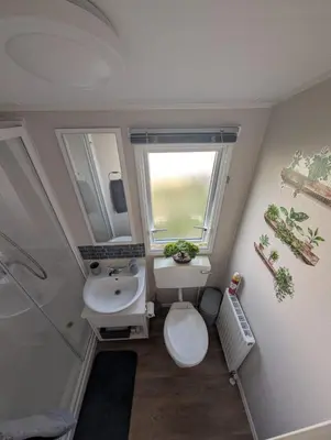 a small bathroom with a toilet and a sink at LuKa25 GC080 in Saint Osyth