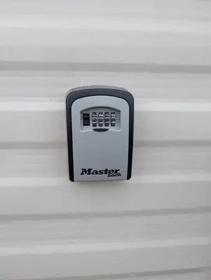 a black and white remote control sitting on a wall at LuKa25 GC080 in Saint Osyth