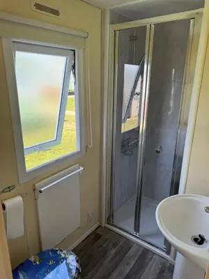 a bathroom with a shower and a sink at Cabana Escape in Little Clacton