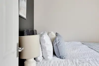 a bedroom with a bed with pillows on it at Cosy 3 bedroom house with Free parking and WiFi in Colchester