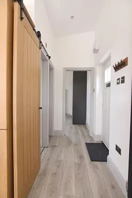 an empty hallway with a door and a wooden floor at Beautiful Lodge in Newmarket with parking in Newmarket