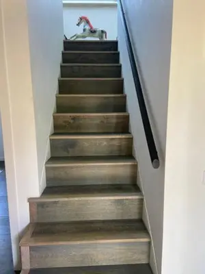 a stairway with wooden steps with a dog on it at Well Barn in Sudbourne