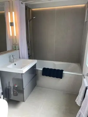 a bathroom with a shower and a sink and a tub at Well Barn in Sudbourne
