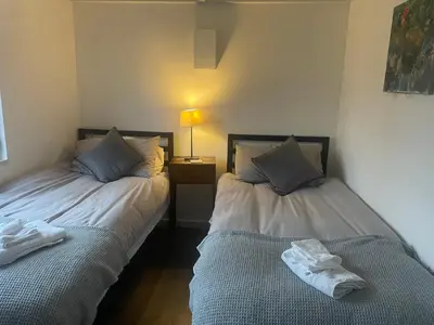 two beds sitting next to each other in a room at Well Barn in Sudbourne
