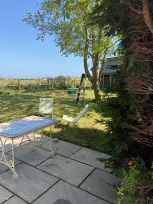 a table and two chairs sitting on a patio at Well Barn in Sudbourne
