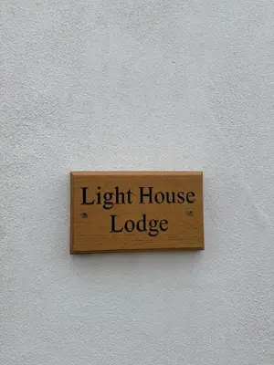 a light house lodge sign on a wall at Lighthouse Lodge in Harwich