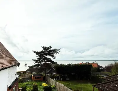 a view of the ocean from a house at Lighthouse Lodge in Harwich