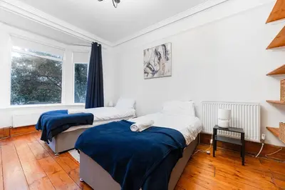a bedroom with two beds and a window at Modern bedrooms-Family -Free Parking-Hi-Speed WiFi-Sleeps 5 in Colchester