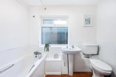 a white bathroom with a toilet and a sink at Modern bedrooms-Family -Free Parking-Hi-Speed WiFi-Sleeps 5 in Colchester